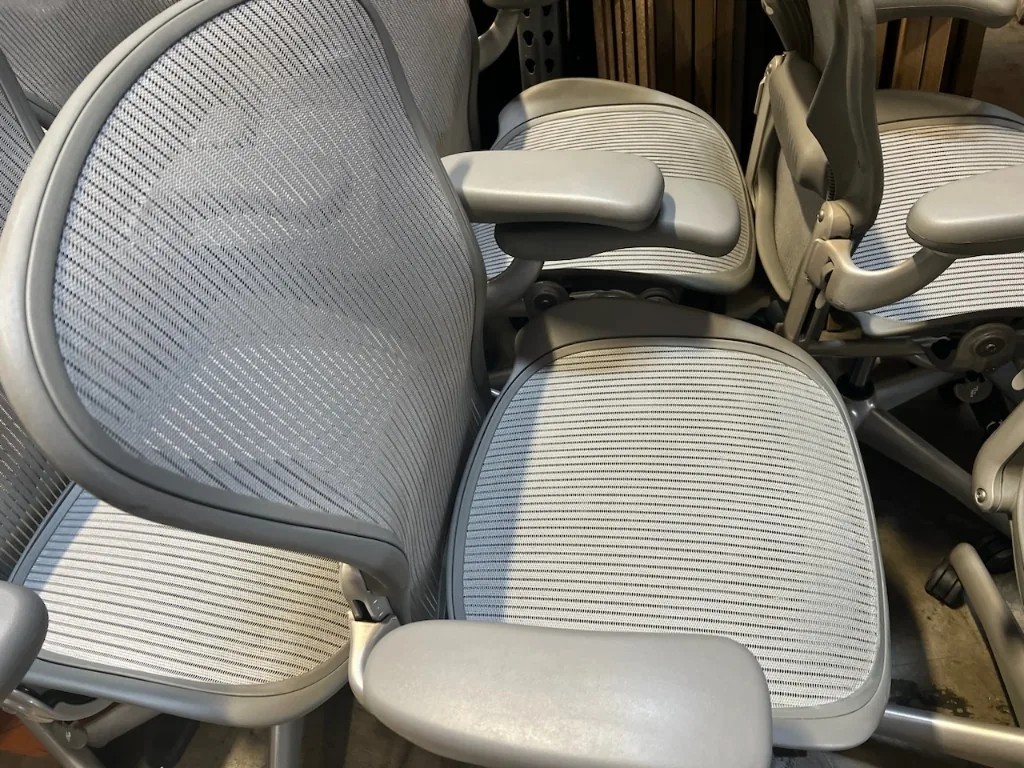 Close-up of used Aeron chair arms and mesh seat