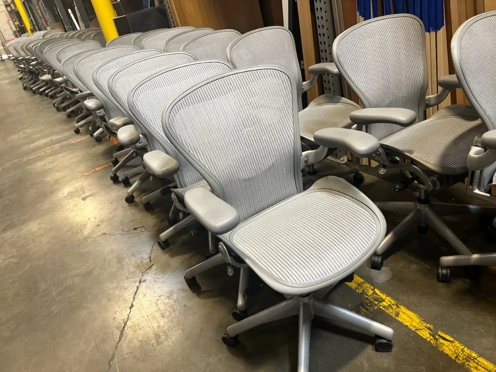 Rows of used Herman Miller Aeron chairs staged in the San Jose warehouse for delivery