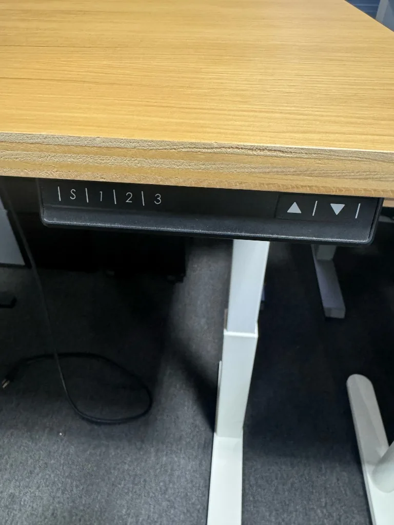Height-adjustable desk control panel with up/down buttons and three memory presets