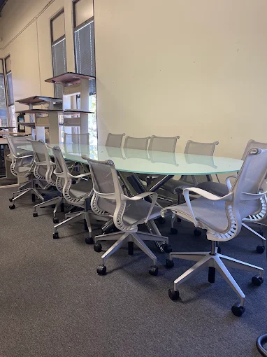 Large modern glass conference table at BT Express Liquidators, San Jose