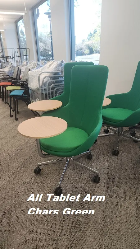 Green lounge chairs with tablet arms staged for delivery